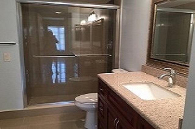 4154 Inverrary Drive, Unit 407 Lauderhill, FL 33319 - Photo 10 of 39 a bathroom with a granite countertop sink a toilet and vanity