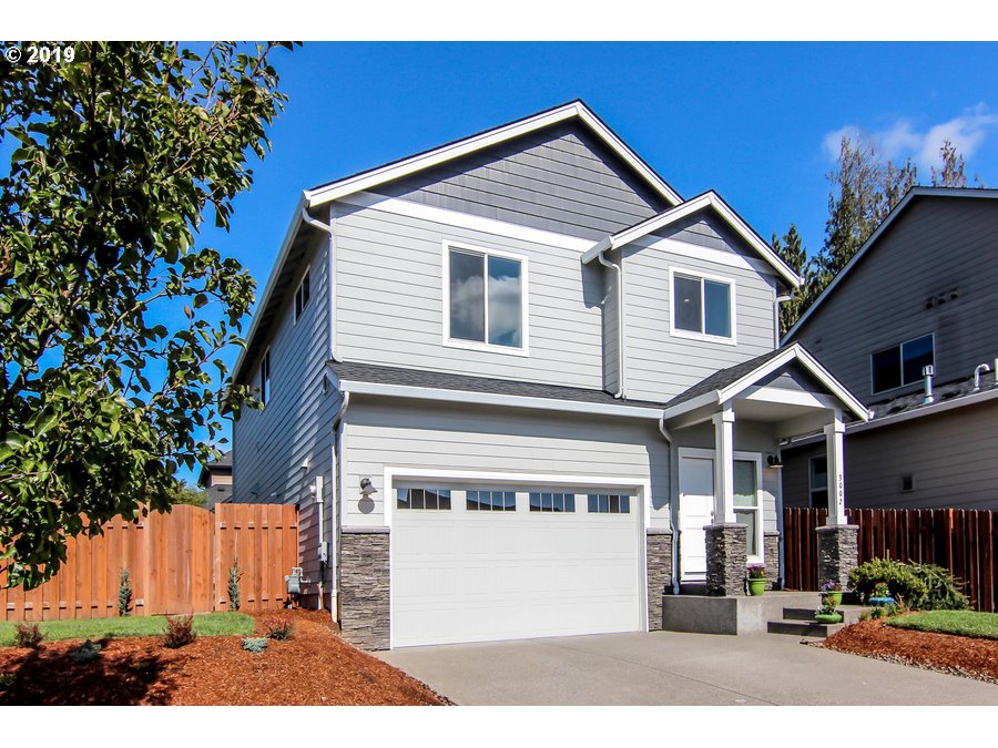 3002 Northeast 171st Street Ridgefield, WA 98642 - Photo 1 of 32 a front view of a house with a yard