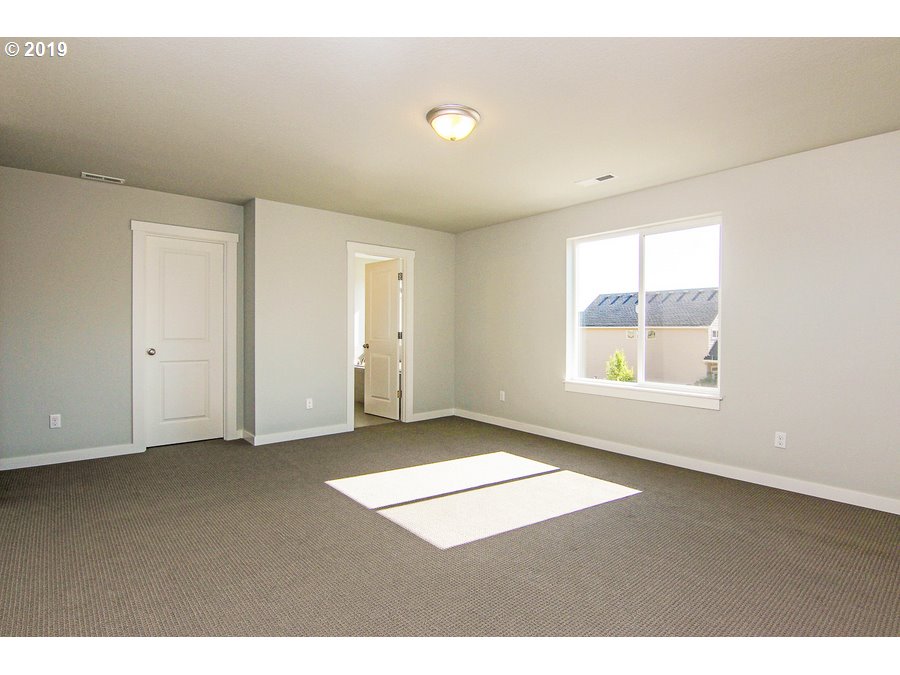 3002 Northeast 171st Street Ridgefield, WA 98642 - Photo 15 of 32 an empty room with windows