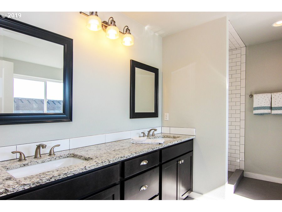 3002 Northeast 171st Street Ridgefield, WA 98642 - Photo 17 of 32 a bathroom with a granite countertop sink double and mirror
