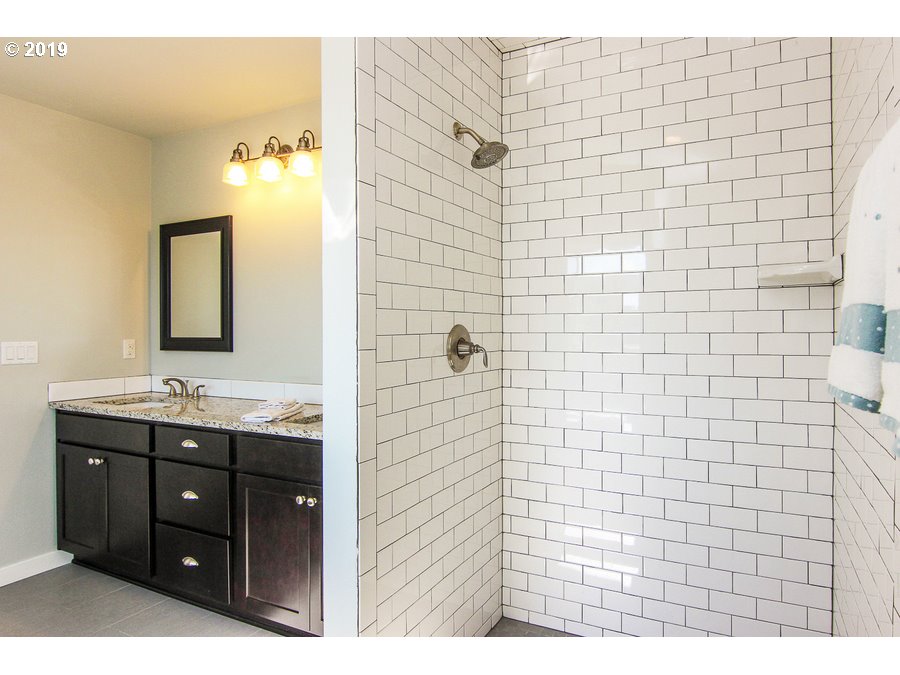 3002 Northeast 171st Street Ridgefield, WA 98642 - Photo 18 of 32 a bathroom with a sink and a mirror