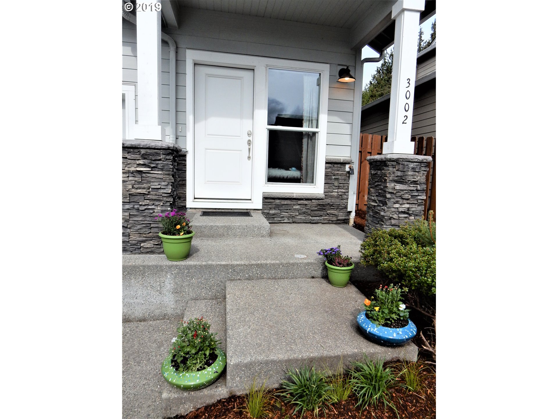 3002 Northeast 171st Street Ridgefield, WA 98642 - Photo 2 of 32 a front view of a house with a yard