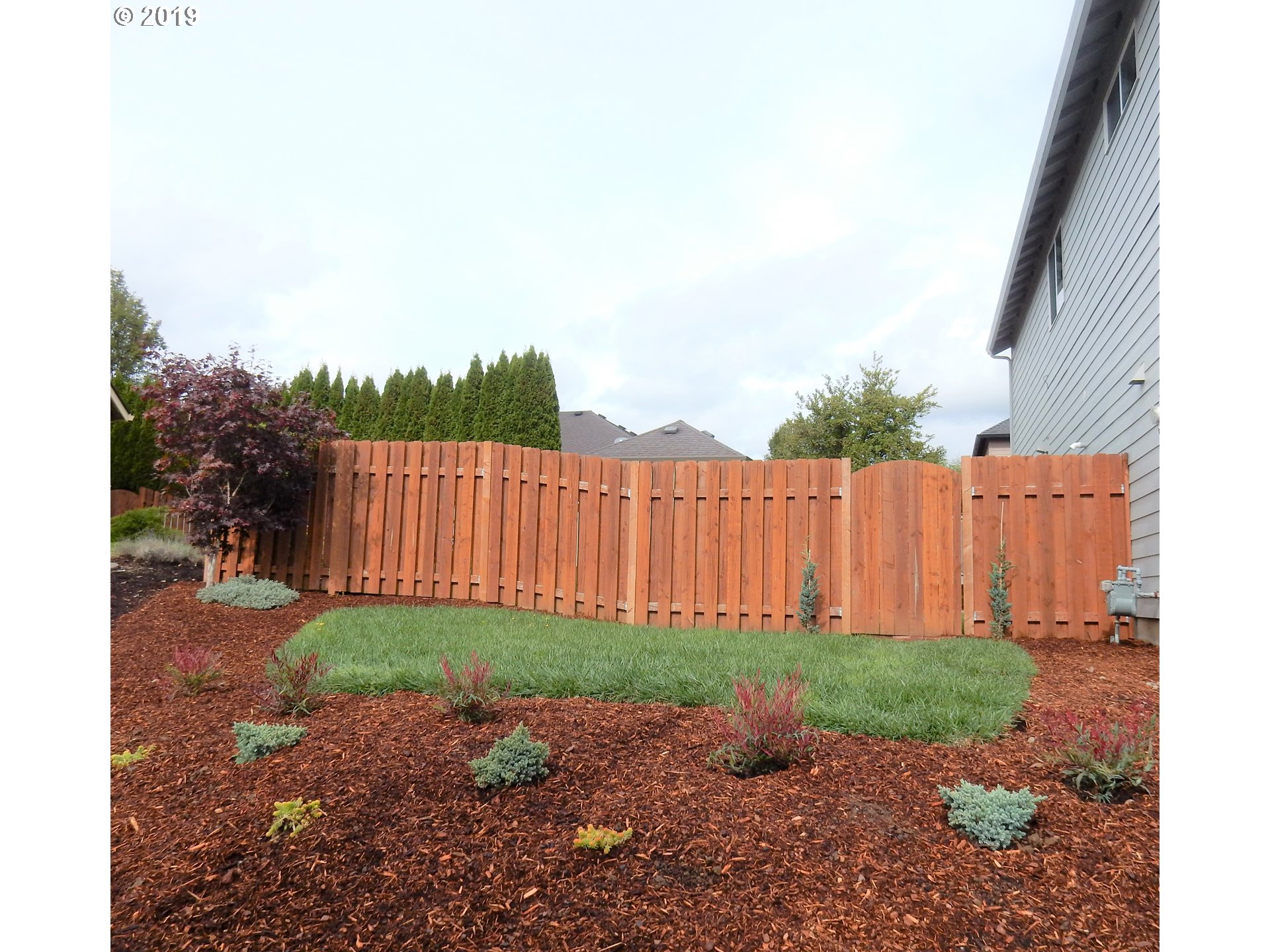 3002 Northeast 171st Street Ridgefield, WA 98642 - Photo 30 of 32 a view of a backyard with potted plants and wooden fence