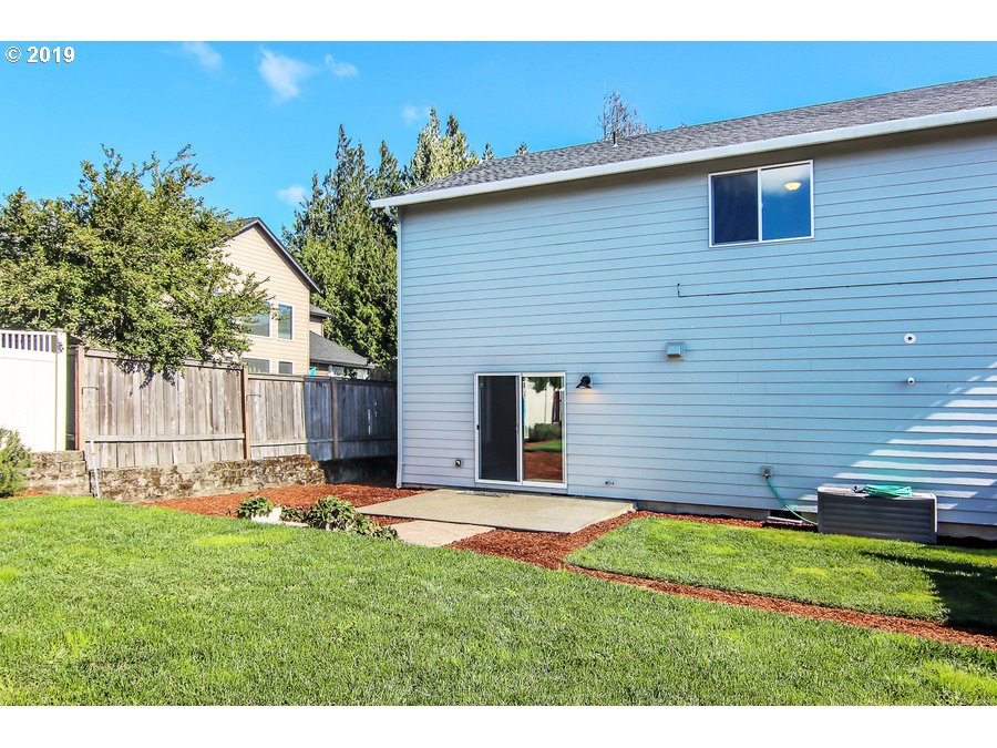 3002 Northeast 171st Street Ridgefield, WA 98642 - Photo 31 of 32 a backyard of a house with lots of green space