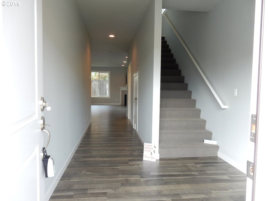 3002 Northeast 171st Street Ridgefield, WA 98642 - Photo 4 of 32 a view of a hallway with wooden floor and staircase