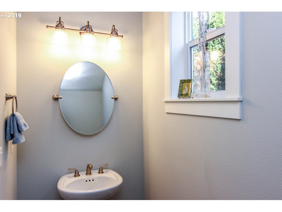 3002 Northeast 171st Street Ridgefield, WA 98642 - Photo 5 of 32 a bathroom with a sink and a mirror