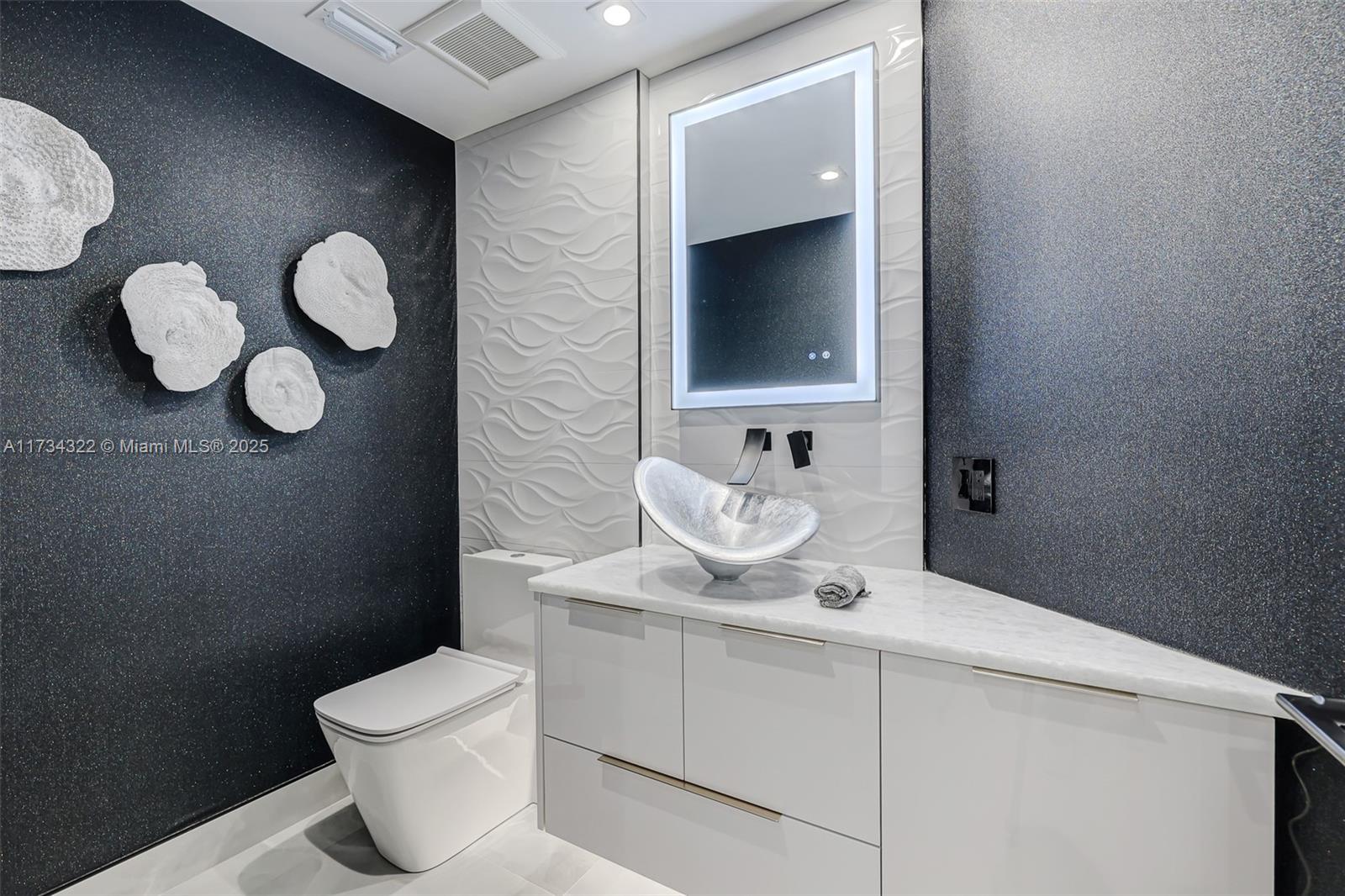 2205 South Surf Road, Unit 4A Hollywood, FL 33019 - Photo 25 of 71 a bathroom with a toilet sink and mirror
