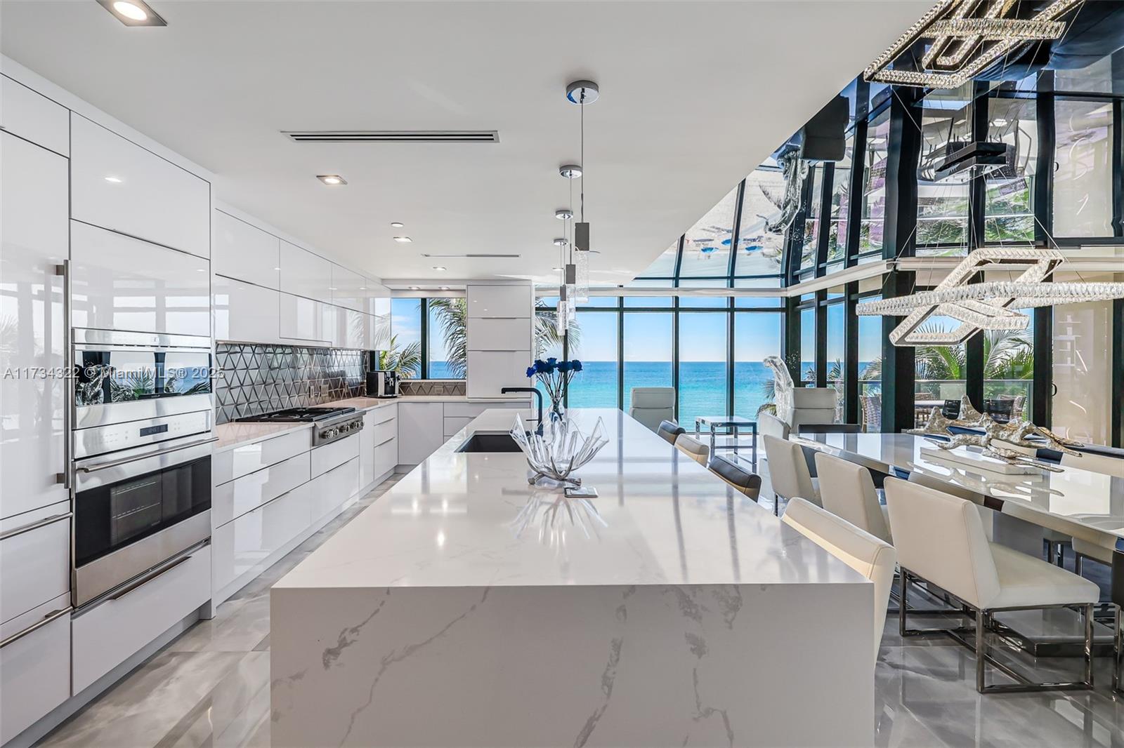 2205 South Surf Road, Unit 4A Hollywood, FL 33019 - Photo 29 of 71 a kitchen with stainless steel appliances kitchen island granite countertop a stove and cabinets