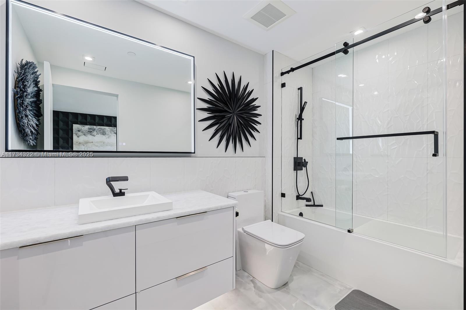 2205 South Surf Road, Unit 4A Hollywood, FL 33019 - Photo 54 of 71 a bathroom with a sink a toilet and a mirror