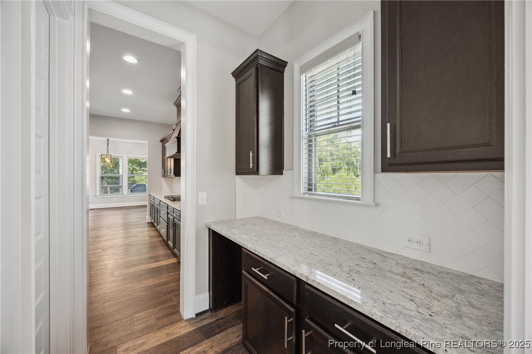 405 Gilpin Way Cary, NC 27519 - Photo 12 of 34 a hallway with sink and wooden floor