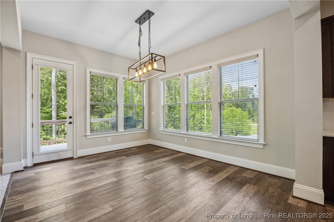 405 Gilpin Way Cary, NC 27519 - Photo 14 of 34 a view of a room with wooden floors chandelier