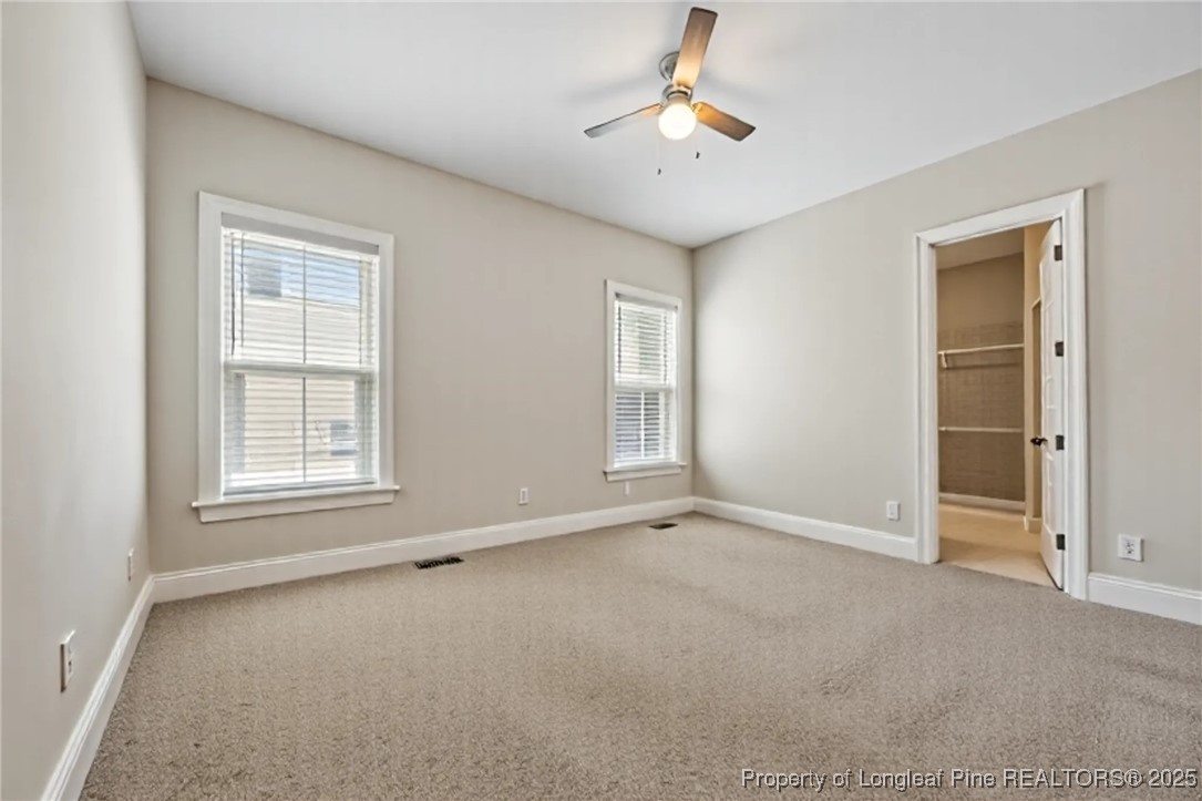 405 Gilpin Way Cary, NC 27519 - Photo 16 of 34 an empty room with windows and fan
