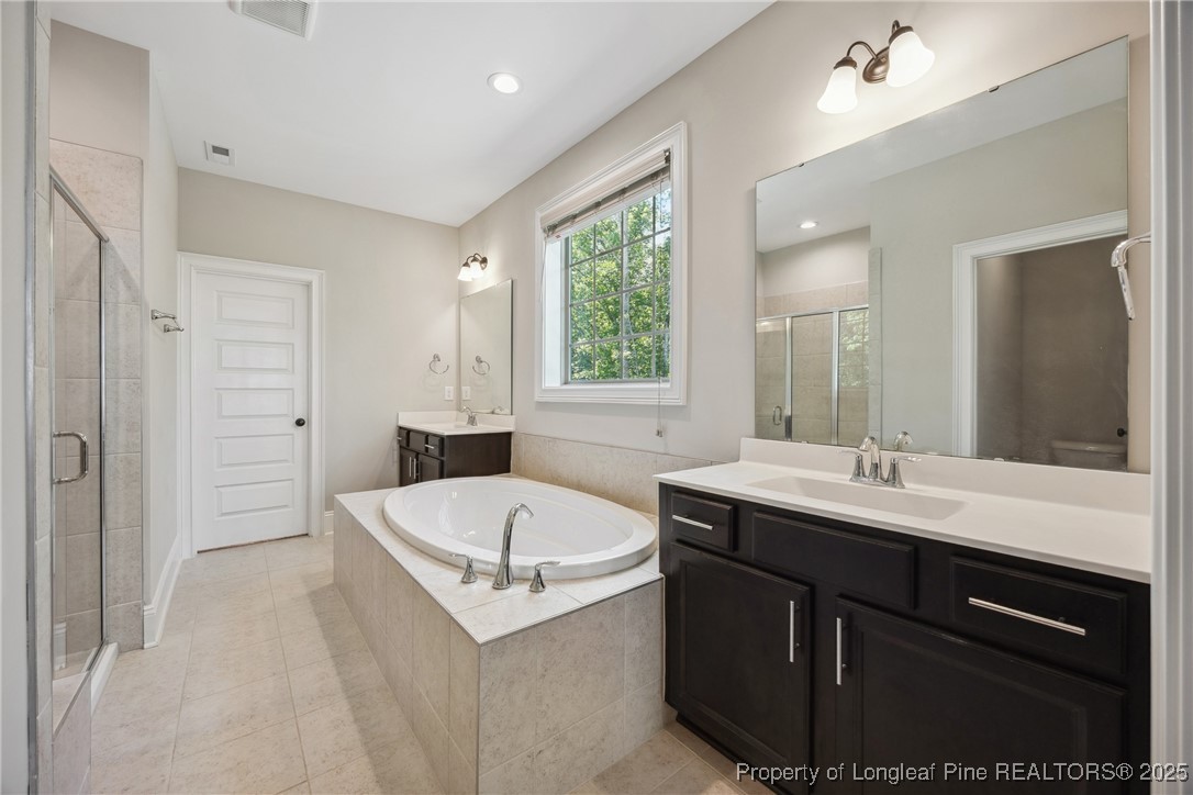 405 Gilpin Way Cary, NC 27519 - Photo 23 of 34 a bathroom with a sink and a bathtub