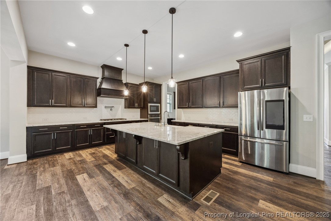 405 Gilpin Way Cary, NC 27519 - Photo 3 of 34 a large kitchen with stainless steel appliances and a refrigerator