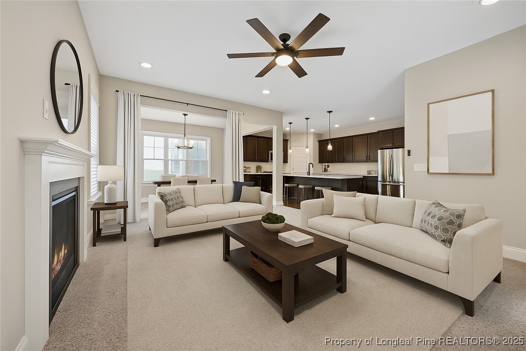 405 Gilpin Way Cary, NC 27519 - Photo 5 of 34 a living room with furniture a fireplace and a large window
