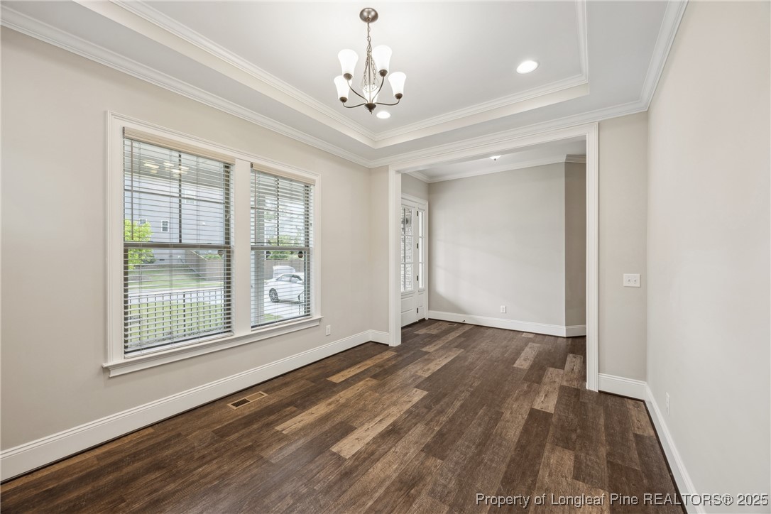 405 Gilpin Way Cary, NC 27519 - Photo 9 of 34 a view of an empty room with a window and wooden floor