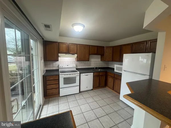 a kitchen with a stove a sink and a refrigerator