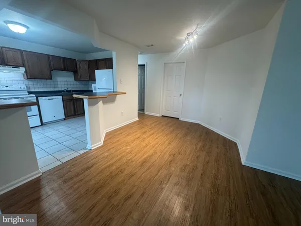 a large kitchen with stainless steel appliances a large counter top and a stove