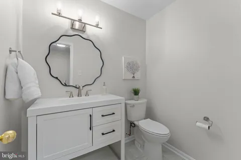 a living room with furniture a fireplace and wooden floor