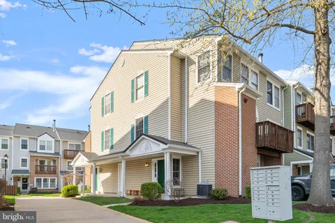a front view of a residential apartment building with a yard