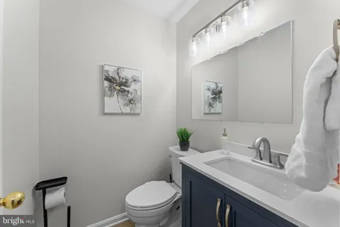 a bathroom with a sink mirror and toilet
