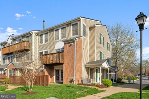 a living room with furniture and a painting on the wall