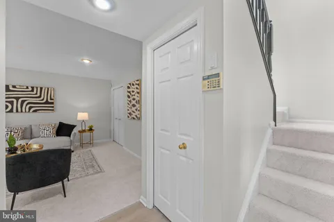 a living room with furniture and painting on the wall