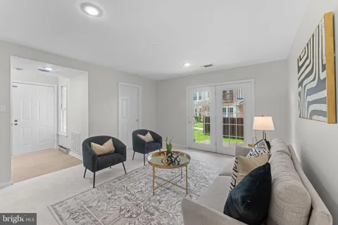 a living room with furniture and a lamp