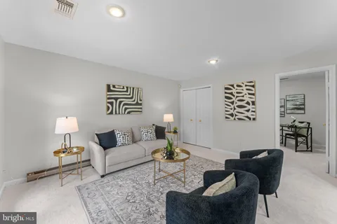 a living room with furniture and a potted plant