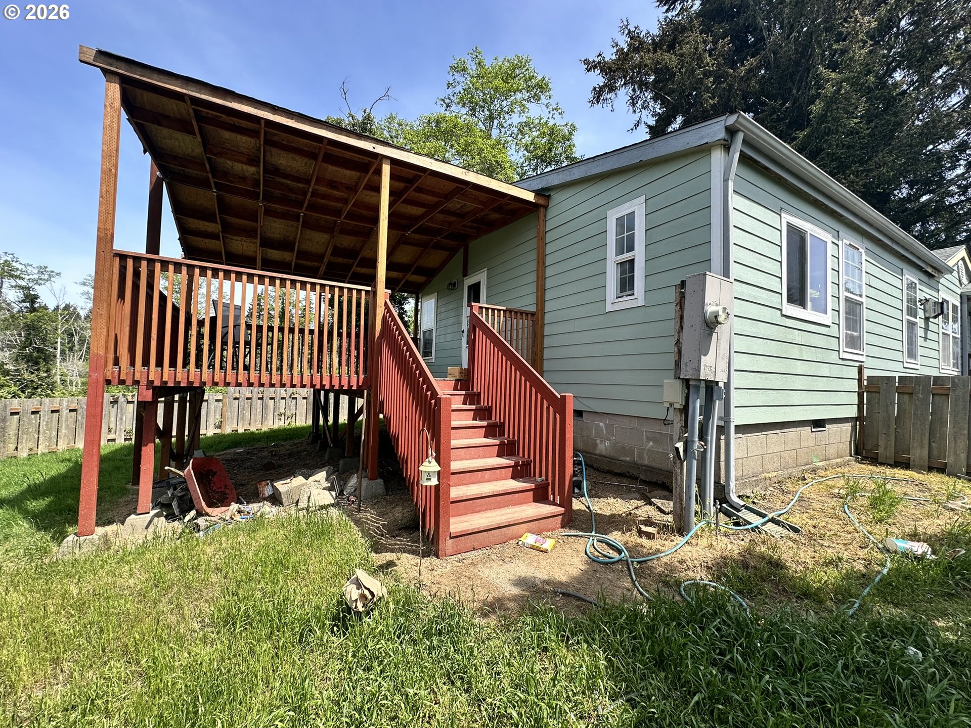 4821 Northeast 50th Street Neotsu, OR 97364 - Photo 2 of 19 a view of a house with wooden floor and a fence