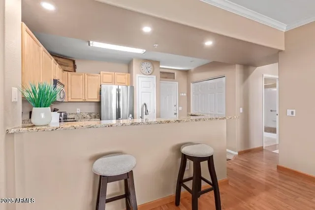 a kitchen with stainless steel appliances granite countertop a stove a sink and a refrigerator