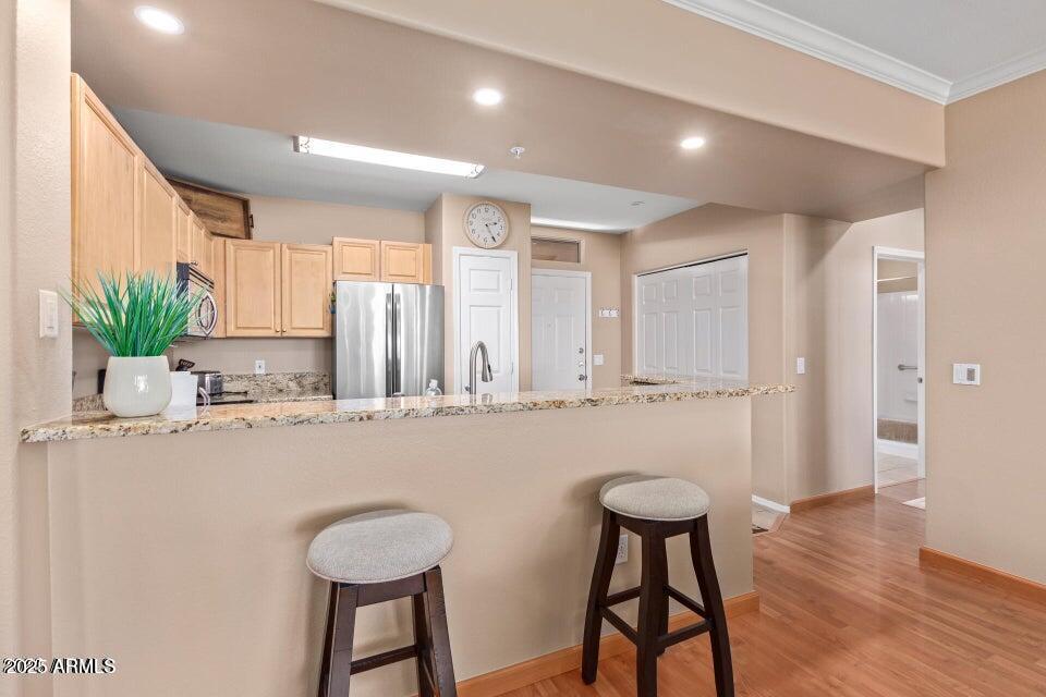 19777 North 76th Street, Unit 1332 Scottsdale, AZ 85255 - Photo 1 of 25 a kitchen with stainless steel appliances granite countertop a stove a sink and a refrigerator