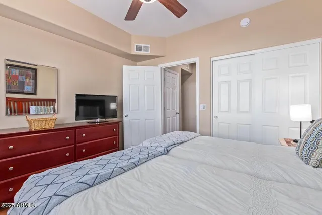 a bedroom with a bed and a television