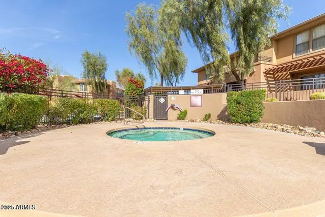 a view of a chairs and table in patio with a lake view