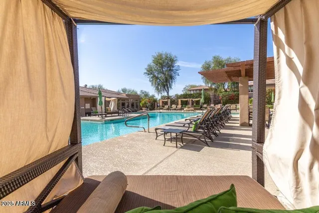 a backyard of a house with table and chairs
