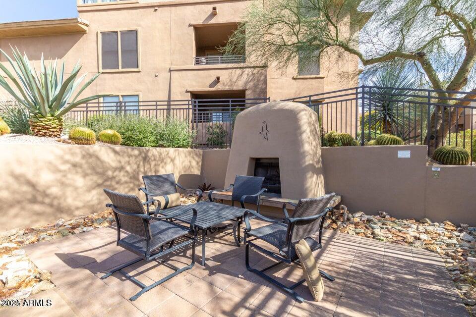 19777 North 76th Street, Unit 1332 Scottsdale, AZ 85255 - Photo 23 of 25 a backyard of a house with table and chairs