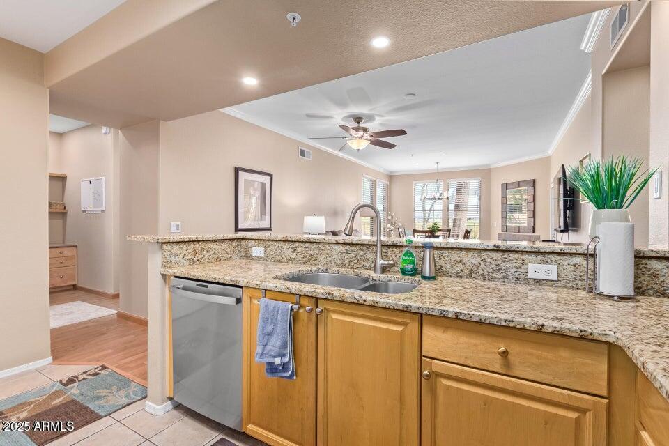 19777 North 76th Street, Unit 1332 Scottsdale, AZ 85255 - Photo 4 of 25 a kitchen with kitchen island granite countertop a sink and a refrigerator