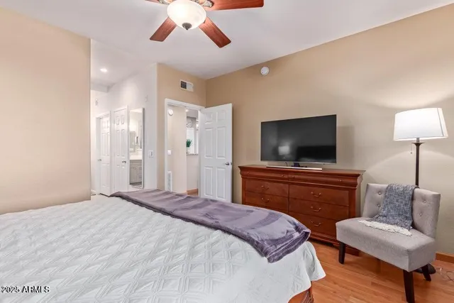 a bedroom with a bed and a flat screen tv