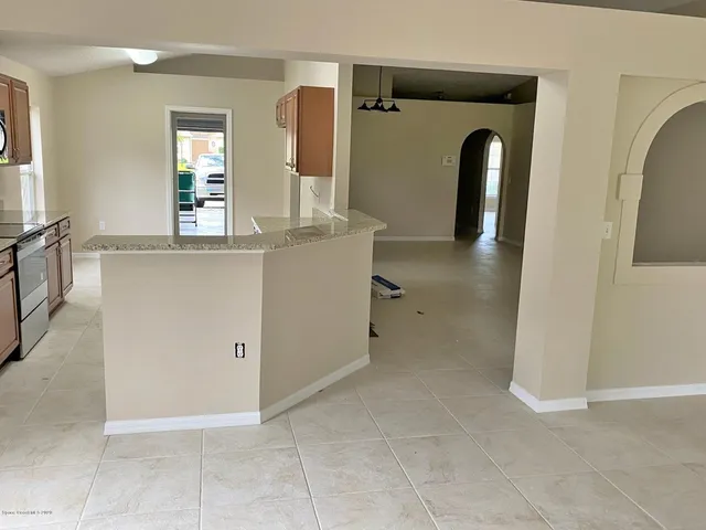 a view of kitchen with stainless steel appliances cabinets and outdoor space