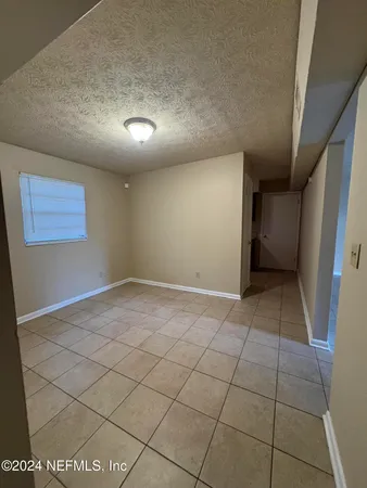 a view of an empty room and a window