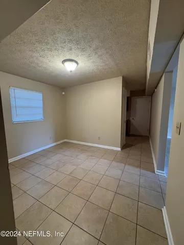 a view of an empty room and a window