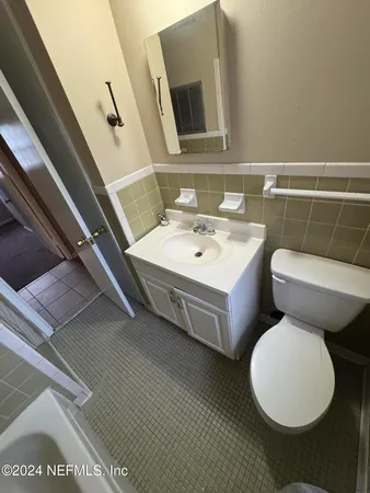 a white toilet sitting next to a bathroom sink