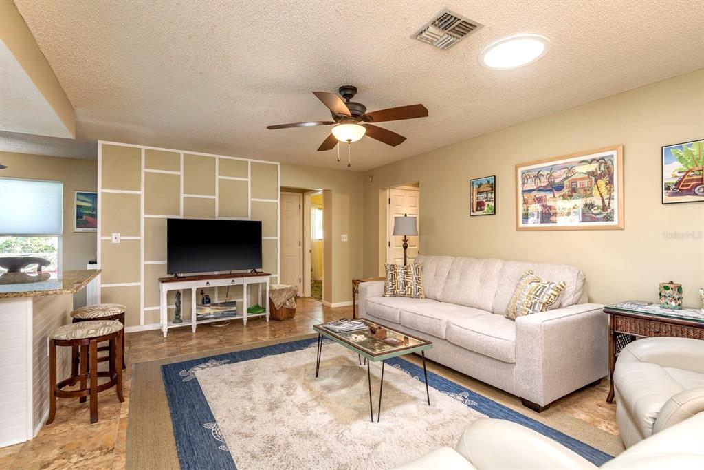 2011 Del-Betmar Road Clearwater, FL 33763 - Photo 13 of 51 a living room with furniture and a flat screen tv