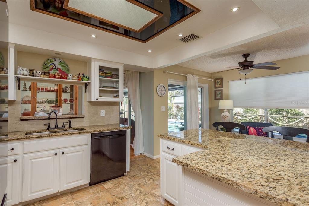 2011 Del-Betmar Road Clearwater, FL 33763 - Photo 18 of 51 a kitchen with stainless steel appliances granite countertop a sink stove and cabinets