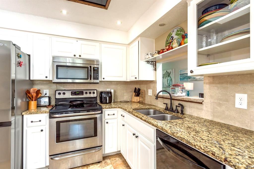 2011 Del-Betmar Road Clearwater, FL 33763 - Photo 20 of 51 a kitchen with a sink stove and microwave