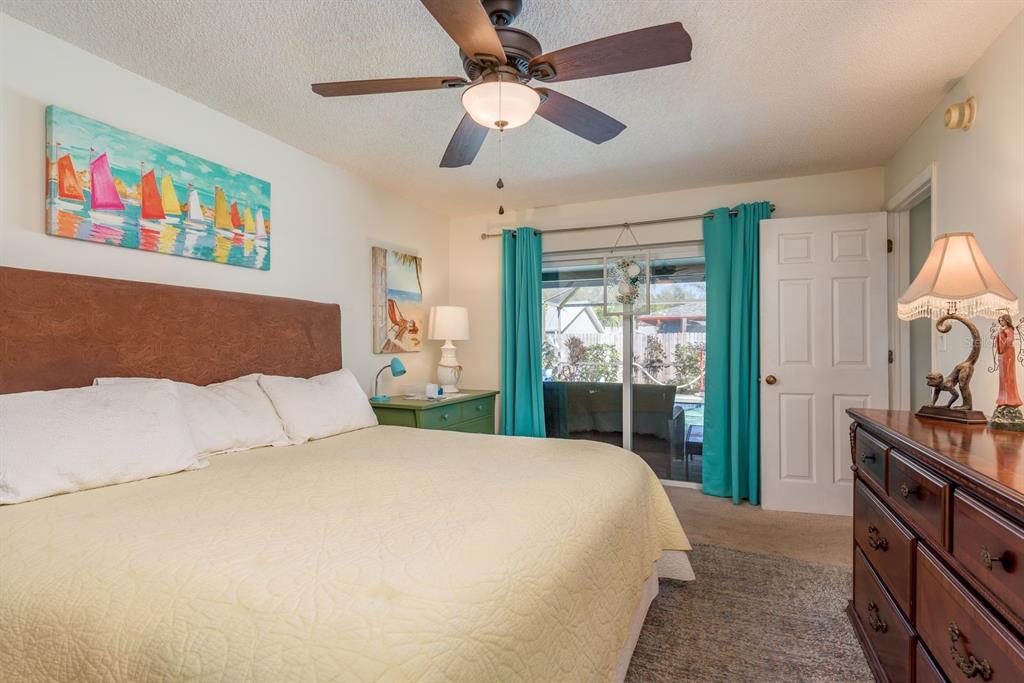 2011 Del-Betmar Road Clearwater, FL 33763 - Photo 24 of 51 a spacious bedroom with a bed and a chandelier