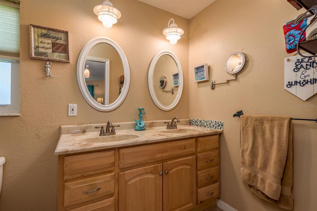 2011 Del-Betmar Road Clearwater, FL 33763 - Photo 25 of 51 a bathroom with a granite countertop double vanity sink and a mirror
