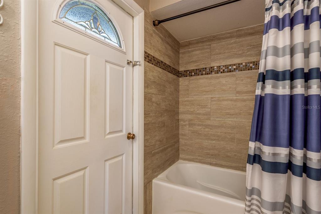 2011 Del-Betmar Road Clearwater, FL 33763 - Photo 30 of 51 a bathroom with a bathtub and a shower