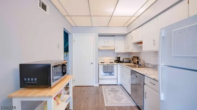 a utility room with cabinets washer and dryer
