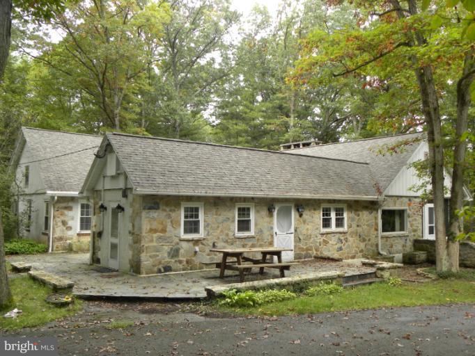 10246 Golf Course Road Fayetteville, PA 17222 - Photo 6 of 11 a front view of a house with a yard and outdoor seating